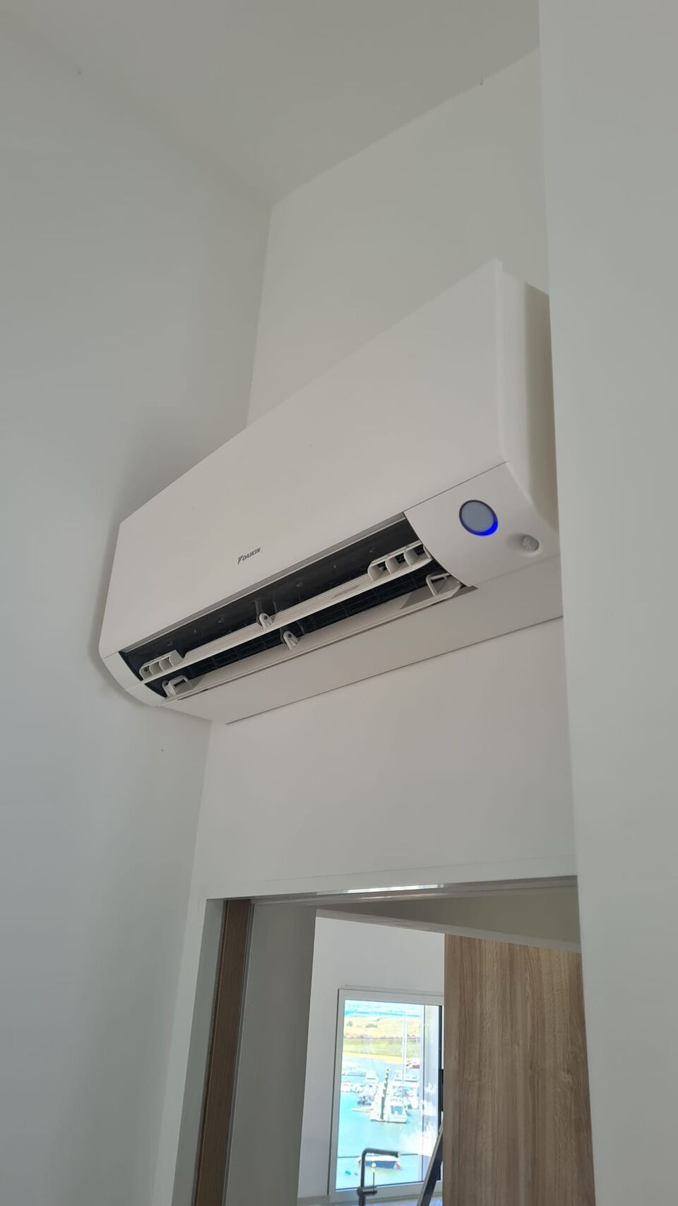 Unidade interior de ar condicionado Daikin instalada em corredor estreito, Alvor